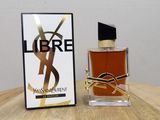 a close up of a bottle of perfume on a table