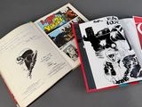 two books that are open on a table