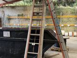 a man that is standing on a ladder next to a boat