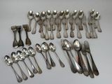 a lot of silver spoons and forks on the table