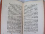 an open book on a table that has a picture on it