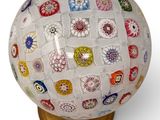 a glass ball that has many different designs on it