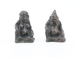 two figurines of a man and a woman sitting on a bench