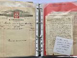 an old document with a note attached to it sitting in a binder