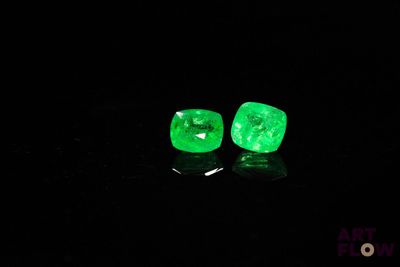 a pair of green emeralds glowing in the dark