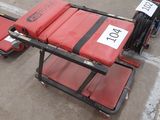 a red stretcher with a number on it in a warehouse