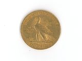 a gold coin with a bird on it on a white surface