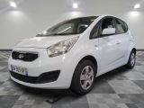 the small white car is parked in a large room
