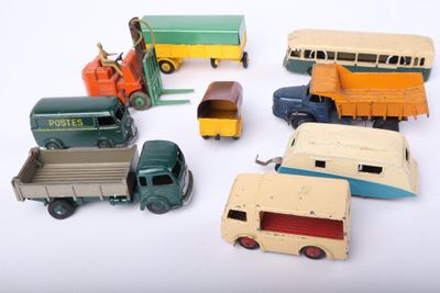 a lot of toy cars and trucks on a white surface