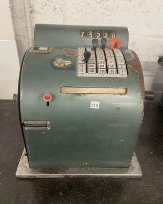 a green machine that is sitting on the floor