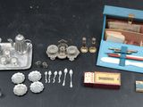 a box of silverware on a table next to other items