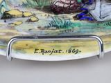 a plate with a picture of a man and a dog on it