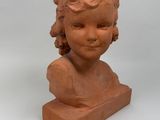 sculpture of a child ' s head on a wooden base