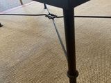 a black table with a glass top on a carpet