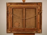 an old wooden easel with a rope hanging from the top of it