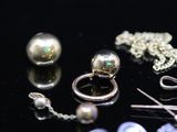 many different types of jewelry on a black surface