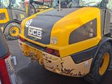 a yellow and black construction vehicle parked in a parking lot
