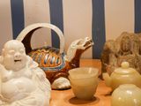 a small statue of buddha sitting on a table next to other items