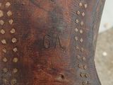 a close up of a brown boot with holes on it