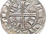 a close up of a coin with a cross on it