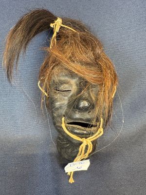 an image of a mask with hair tied to it ' s head