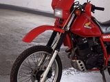a red motorcycle that is parked in a garage