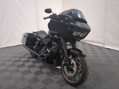 a black motorcycle that is parked on a checkered floor