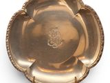 an antique silver plate with a decorative design on the rim