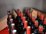 many bottles of wine sitting on a red table
