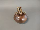 a small vase with a bunch of sticks sticking out of it