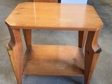 a small wooden table with a shelf underneath it