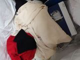 a pile of clothes that is on a bed