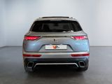the rear end of a silver suv parked in a room