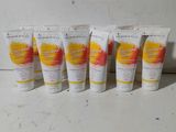 four tubes of hand creams are lined up on a counter