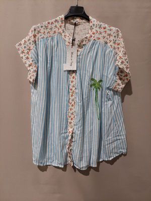 a shirt hanging on a hanger with a tag on it