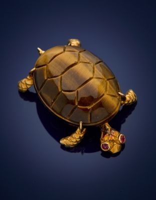 an image of a turtle broochle with a pair of shoes on it ' s feet