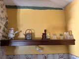 a shelf with a tea pot, tea pot, and other items on it