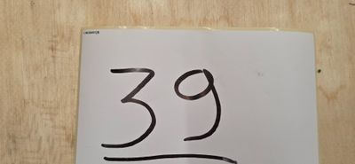 une pancarte portant le chiffre 39, posée sur une table