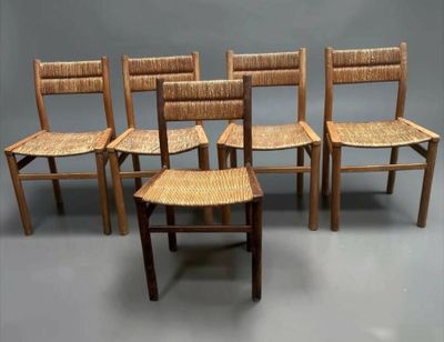 four wooden chairs are lined up in a row on a gray surface