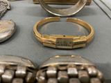 many different types of jewelry on display in a glass case