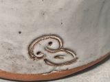 a close up of a white vase with a number on it