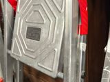 a ladder that has a red handle on top of it
