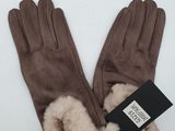the gloves are brown with a fur cuff and a tag on it