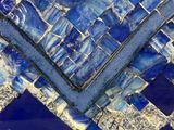 a close up of a blue and white mosaic tile