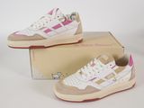pair of white and pink sneakers sitting on top of a box