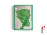 un motif de feuilles vertes dans un cadre vert accroché à un mur blanc