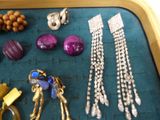 a tray that has many different types of jewelry on it