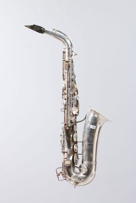 an image of a silver saxophone sitting on top of a white surface