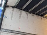 a skateboarder doing a trick in a parking garage