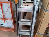 a ladder that is next to a refrigerator in a room
